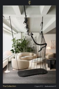 Modern living room interior at Stadhouderskade 85 featuring a sculptural black swing, curved cream sofas, and minimalist decor with abundant natural light.