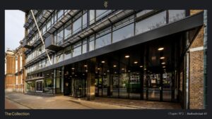 Modern office building entrance at Stadhouderskade 85 in Amsterdam with glass facade and overhanging canopy.