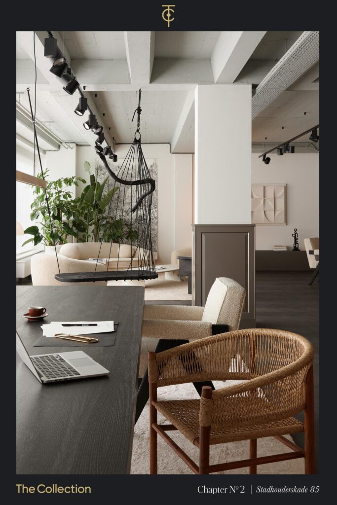 Modern office interior at Stadhouderskade 85 featuring a dark wooden table, designer chairs, a hanging swing seat, and contemporary decor.