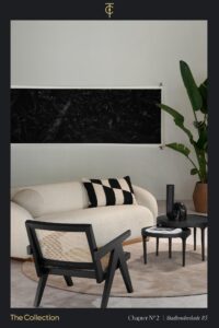 Modern interior with a cream sofa, black accent chair and decor, a large plant, and monochrome artwork at Stadhouderskade 85.