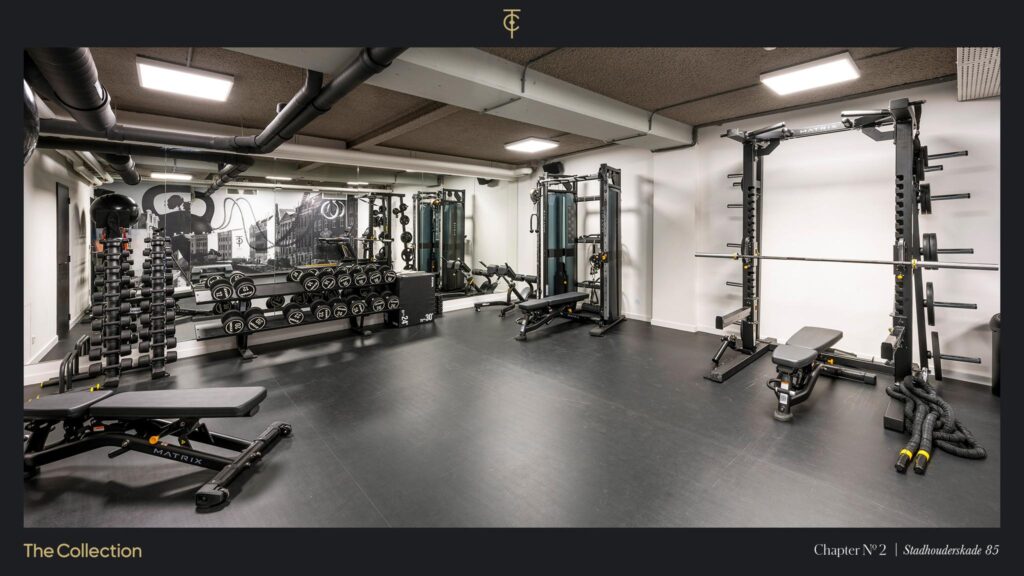 Modern gym with strength training equipment, including weights, benches, and resistance machines, at Stadhouderskade 85.