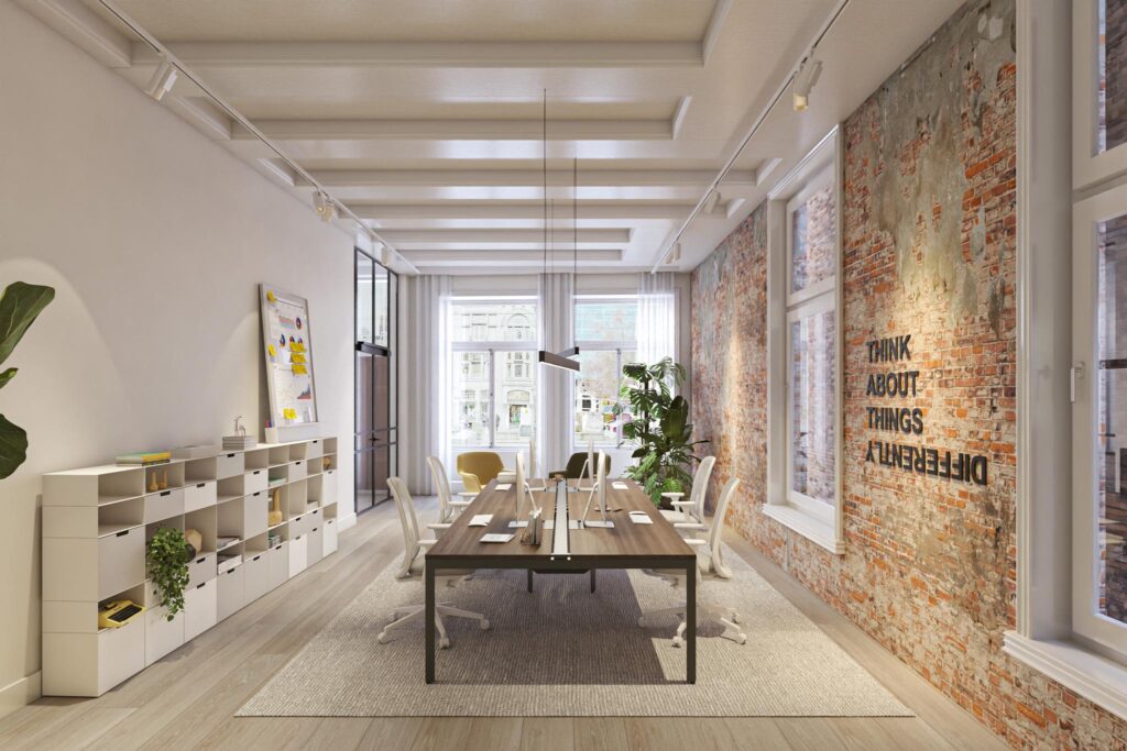 Modern kantoorinterieur aan het Rokin met een lange vergadertafel, industriële bakstenen muur en de tekst "Think about things differently".