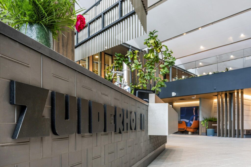 Modern hotel lobby of Zuiderhof with contemporary design elements, indoor plants, and stylish seating area.