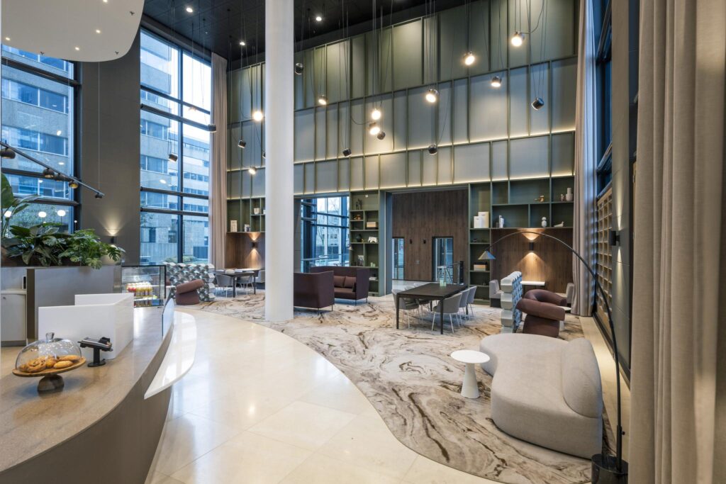 Modern lobby interior of Amstelplein with high ceilings, contemporary furniture, and large windows offering natural light.