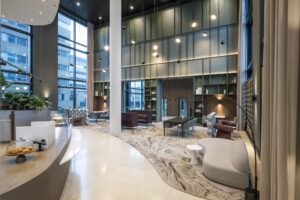 Modern lobby interior of Amstelplein with high ceilings, contemporary furniture, and large windows offering natural light.