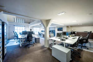 Modern kantoorinterieur aan de Herengracht met meerdere werkplekken en computerschermen.