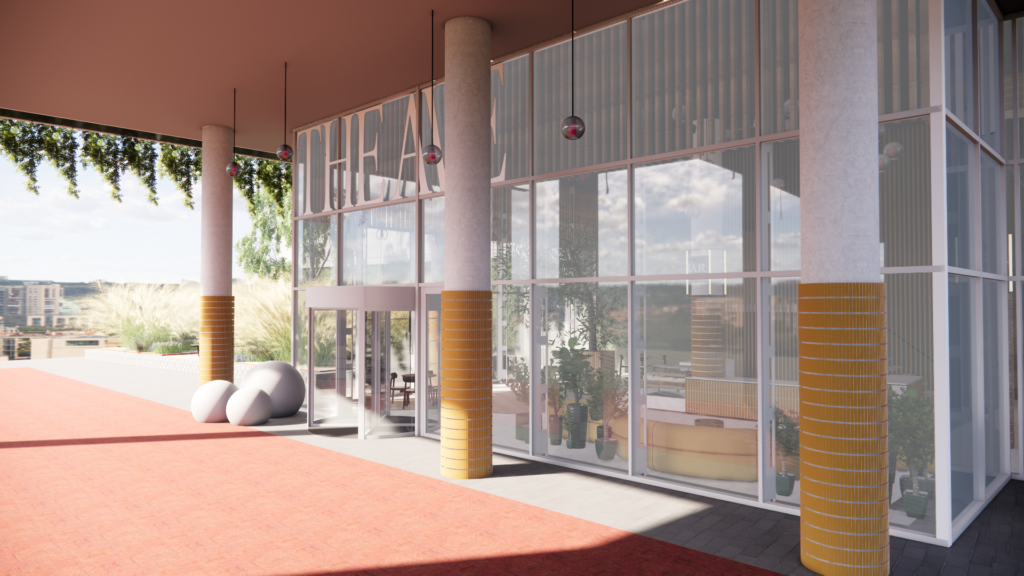 Modern glass entrance of a theater building with tall columns, potted plants, and a red walkway.