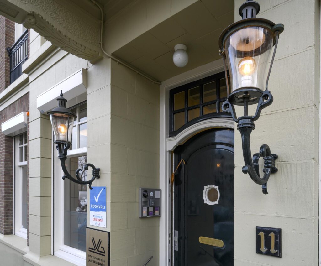 Entrance of a historic building at Concertgebouwplein 11 with vintage lanterns and a black door.