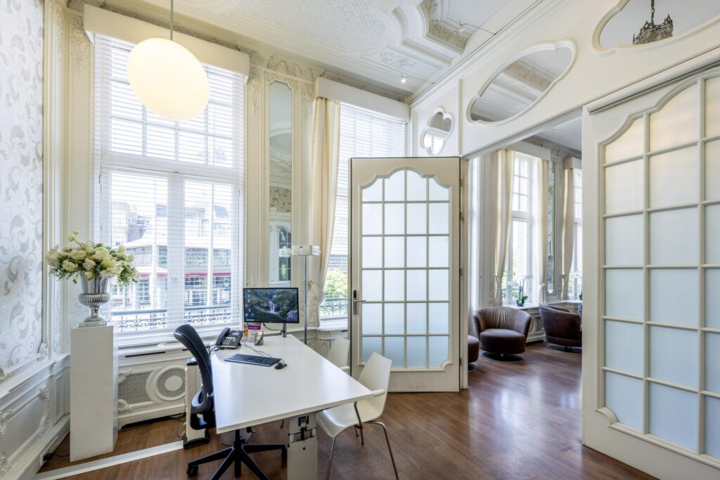 Elegant office interior at Concertgebouwplein with classic decor, high ceilings, and large windows.