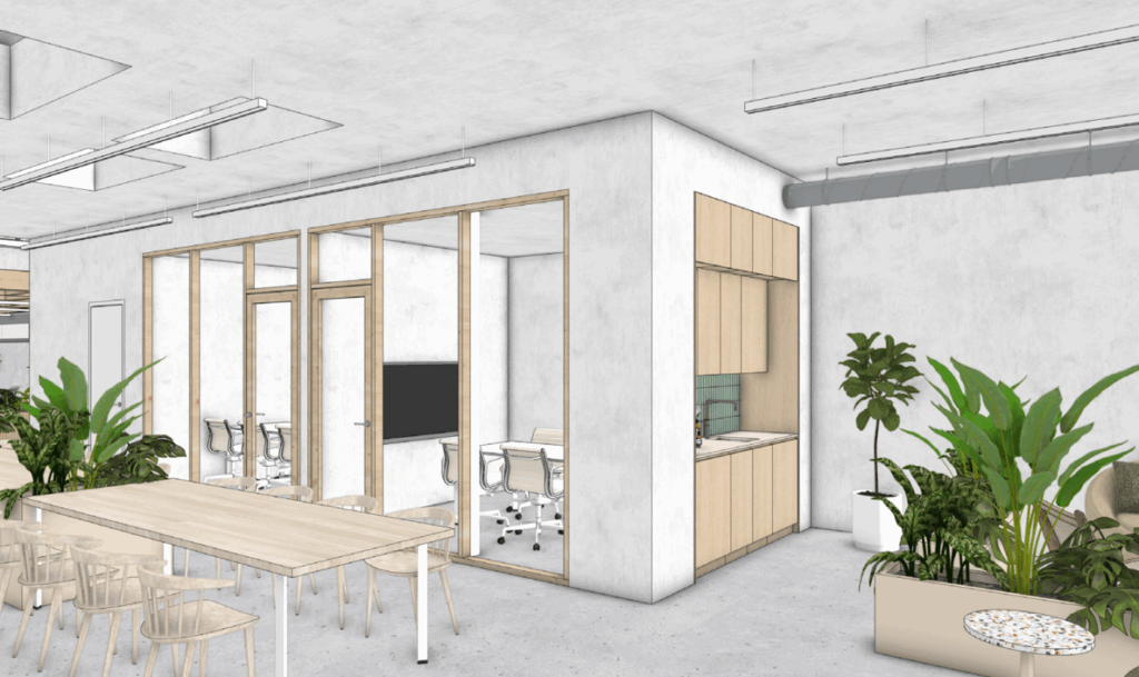 Modern office interior with a meeting room, kitchenette, long wooden table, and indoor plants.