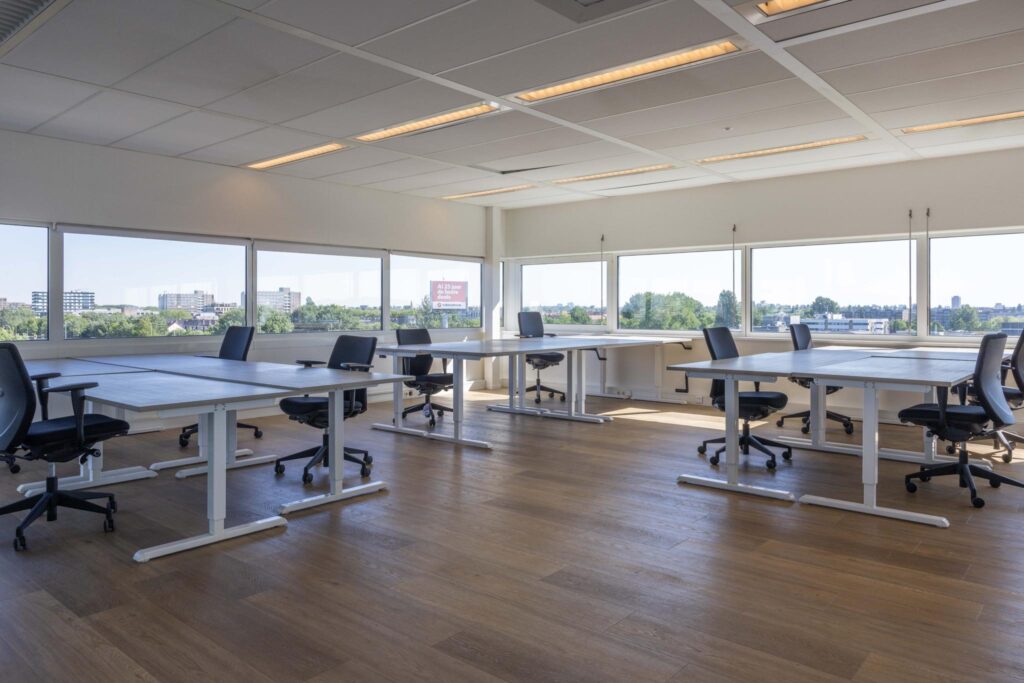 Bright and spacious modern office space on Overschiestraat with large windows and multiple workstations.