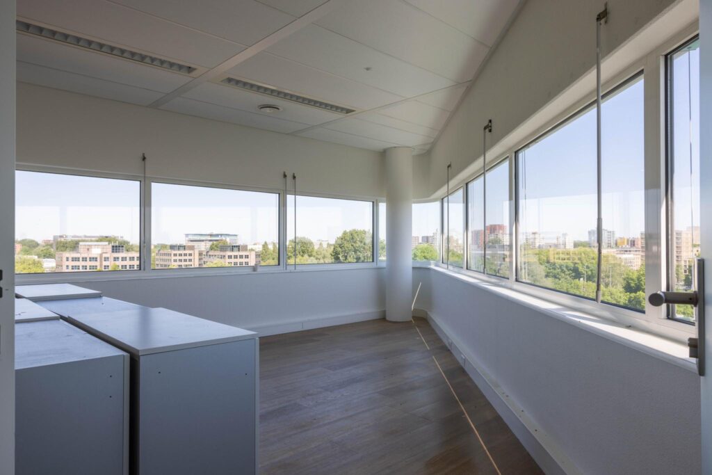 Bright corner office space at Overschiestraat with large windows and a view of the city.