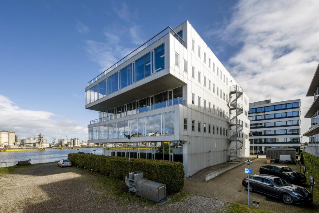 Modern office building on Moermanskade with a view of the harbor and a spiral emergency staircase.