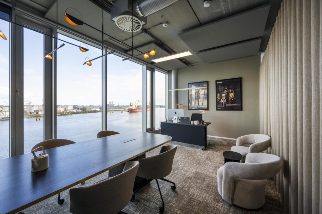 Modern office space on Moermanskkade with large windows overlooking the harbor and contemporary furnishings.