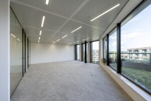 Modern empty office space with large windows and city views at Gelrestraat.