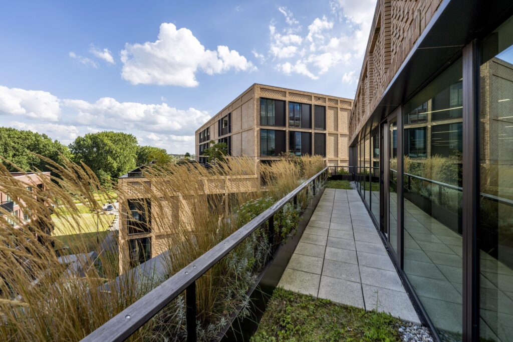 Modern office buildings on Gelrestraat with a landscaped terrace and glass facade.