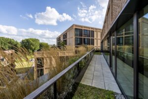 Modern office buildings on Gelrestraat with a landscaped terrace and glass facade.