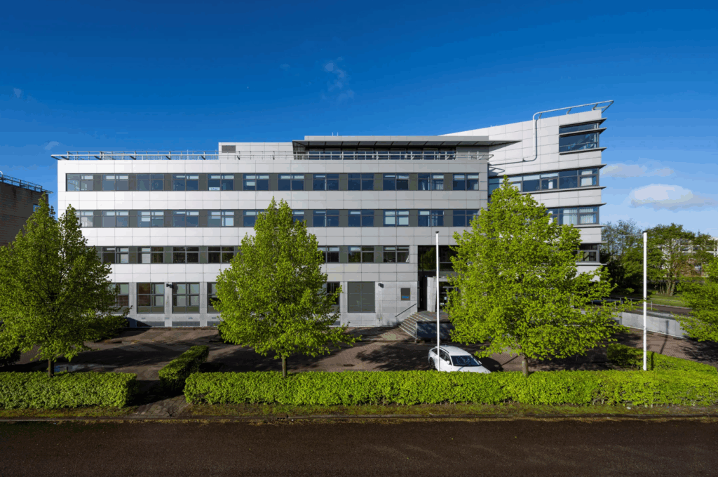 Modern office building on Boeing Avenue with large windows and trees in front.