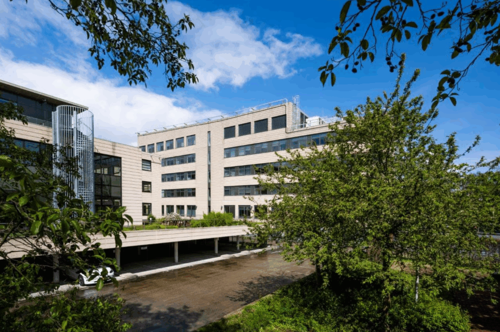 Modern office building on Boeing Avenue surrounded by green trees under a blue sky.