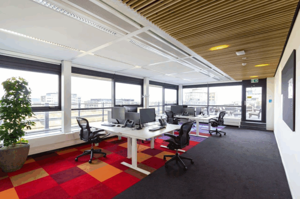 Modern open-plan office space on Boeing Avenue with multiple desks, computers, and large windows providing natural light.