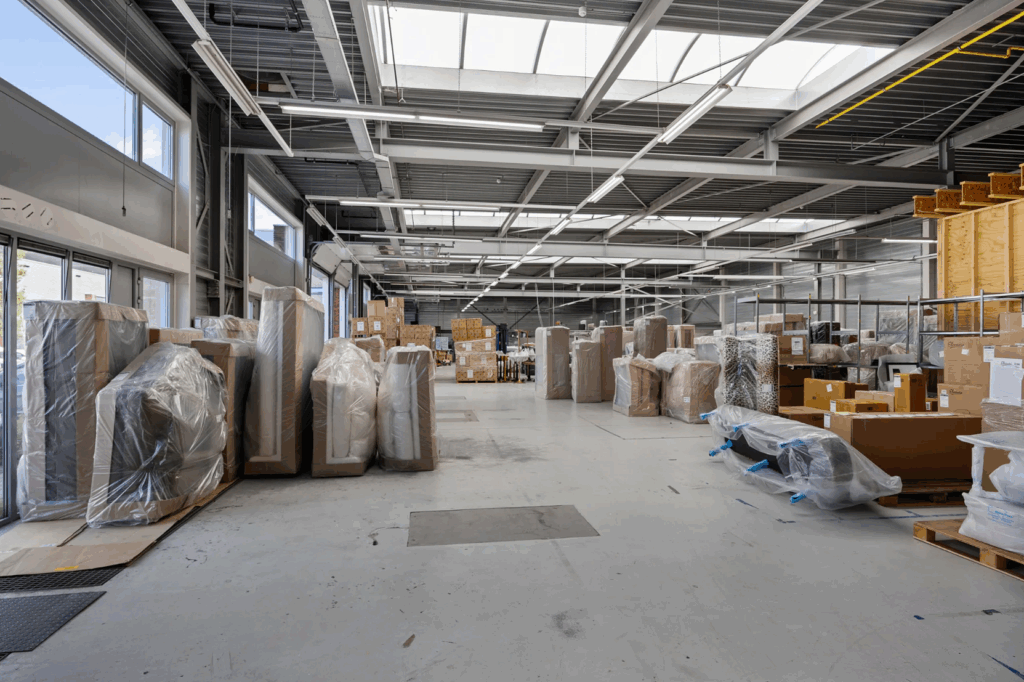 Spacious warehouse interior on Schaafstraat filled with packaged furniture and boxes.